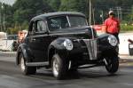 Jim Sartori's 1940 Ford Coupe is not just a pretty face. It runs 10.30s at the drags and we see daylight under that left front tire. Sartori is a '40 Ford freak who has several examples in his collection, this one was our favorite, head through the photo gallery to find out why. You can also watch action video at http://www.bangshift.com/blog/Car-Feature-Jim-Sartori-s-Aluminum-FE-Powered-1940-Ford-Deluxe-Coupe.html  &raquo; Click to zoom ->
