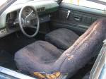 The interior of the Camaro was gross olive green with fake sheepskins. While it looks sort of presentable in the photo, the dash was really falling apart.  &raquo; Click to zoom ->