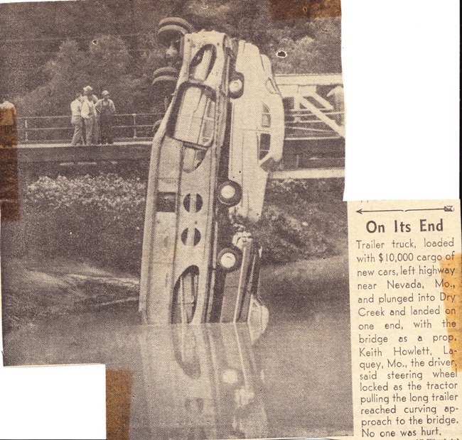 Car transporter off of bridge