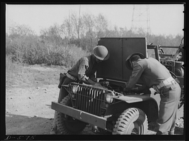 GIs wrenching on their Jeep